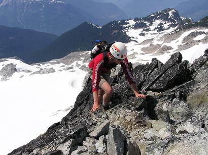 Reid scrambles the final few metres of the North Ridge to the summit.